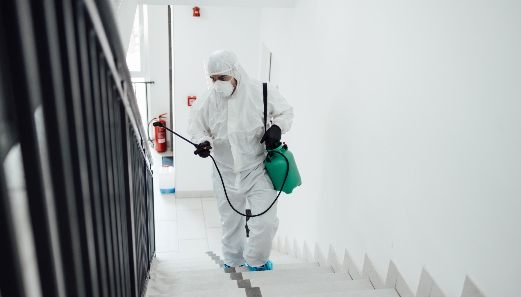 A tech using eco-friendly disinfection methods for a restoration in commercial building